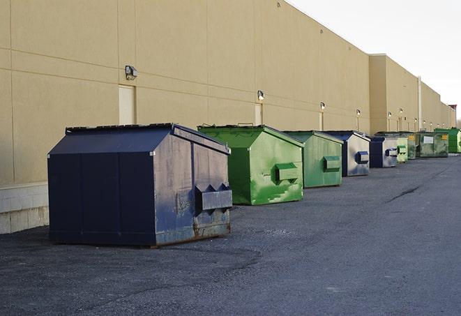 a fleet of red and blue construction dumpsters available for use in Austin IN